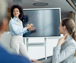 Black Female Entrepreneur Presenting Business Growth Chart Meeting Office